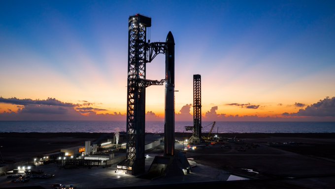 A SpaceX Starship rocket stands on the launch pad at sunset, illuminated against a colorful coastal sky. The image captures the "opportunistic" launch attempt referenced in the post, showing the massive Starship vehicle fully stacked on its orbital launch mount, ready for a flight test.
