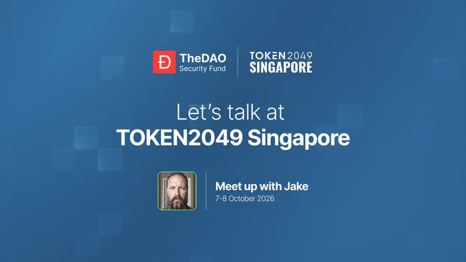 A blue promotional graphic for TheDAO Security Fund at TOKEN2049 Singapore reads 'Let's talk at TOKEN2049 Singapore' with 'Meet up with Jake, 7-8 October 2026' below a photo of a bearded man.