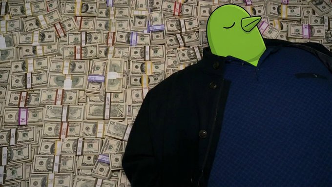 A Pepe the Frog character with a smug, content expression wearing a dark jacket and blue sweater, standing in front of a wall completely covered in bundles of US dollar bills.