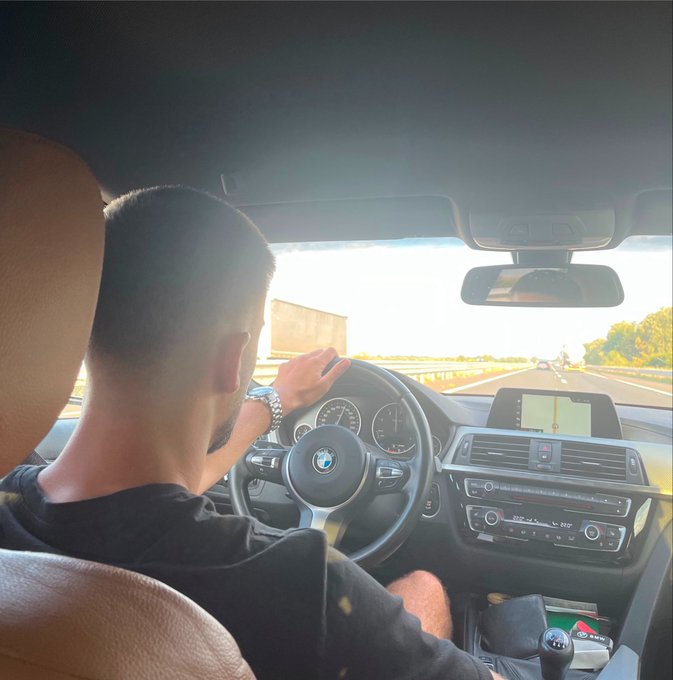 A man drives a BMW on a highway, one hand on the steering wheel, while the caption humorously critiques someone losing crypto on the Solana network by not using the Solflare wallet.
