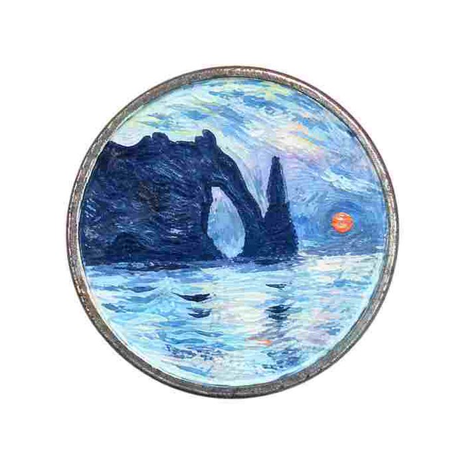 A circular collectible coin or medallion featuring an artistic reproduction of Vincent van Gogh's painting depicting a dark rocky arch over water under a swirling night sky with an orange sun or moon.