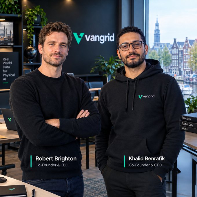 A professional company photo for "vangrid" featuring two co-founders—Robert Brighton (Co-Founder & CEO) and Khalid Benrafik (Co-Founder & CTO)—standing together in dark branded clothing within a modern office setting with a city view.