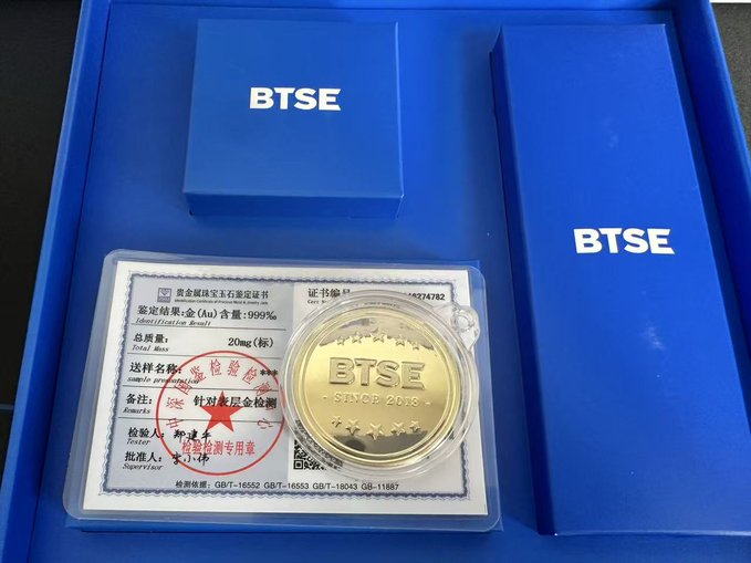 A BTSE branded gold commemorative coin displayed in a presentation box alongside a certificate, featuring the text 'BTSE' and 'SINCE 2018'.