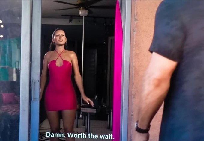 A woman in a red dress stands in a doorway with a confident expression, while a man's arm is visible in the foreground. The caption reads "Damn. Worth the wait." This humorously captures the excitement and anticipation of someone who has held onto XRP for a long time, finally seeing a massive price surge as worth all the patience and waiting.