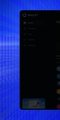 A dark screen with a blue pixelated background, possibly showing a list or menu interface with small text and icons barely visible.