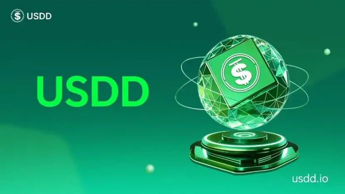 A promotional graphic for USDD with a green geometric sphere featuring a dollar sign orbiting above a metallic pedestal, displaying the "USDD" name, ticker, and website "usdd.io" against a green background. The futuristic design symbolizes the stablecoin's financial strength and growth, complementing the message about USDD's record-breaking $7.66 million in Q2 2026 revenue.