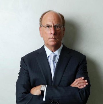 A black older man wearing glasses, a dark suit, and a light blue tie stands with arms crossed against a plain wall. The image likely relates to BlackRock, the world's largest asset manager whose Ethereum ETF ($ETH) clients have sold $75.07 million worth of shares.