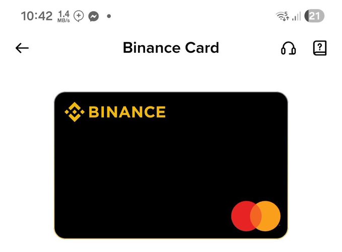 The image shows a black square credit card with the word "BINANCE" written on it in yellow letters. The text also mentions that this card can be used for virtual currency, which implies that users can make purchases online using the card without needing physical cash or bank accounts. This is particularly useful in South Asia where traditional banking services might not be as readily available or convenient.