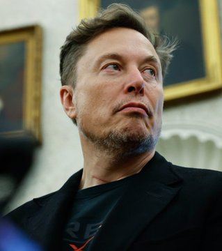 A man with short dark hair and a slight smile, wearing a black t-shirt, looks upward in a thoughtfully composed indoor setting with framed artwork visible in the background. The image accompanies the announcement of "X Money," a new financial service associated with Elon Musk's X platform, launching with features like deposit yields and cashback rewards.