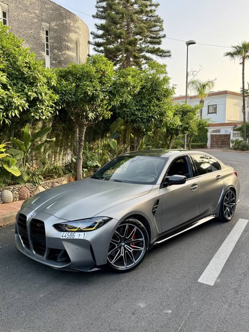 The image features a silver BMW car parked on the side of a street with trees behind it, giving off an impression that it's a sunny day. The car appears to be in good condition and well-maintained. The photo also includes text that reads "Gm CT Its Friday and the weekend is here Crypto still feels harder than it should for normal users. Too many apps expect people to think about chains, bridges, wallets, gas, and execution before they can even do something simple. That's why @useTria feels refreshing." This message seems to be related to the car in the image, possibly discussing the car's features or performance.
