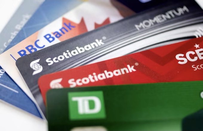 A fan of Canadian bank credit cards displays visible branding from RBC Bank, Scotiabank (including a "Momentum" card), and TD (Toronto-Dominion Bank), representing several of the major financial institutions mentioned in the accompanying post about a joint tokenized deposit and blockchain-based payments initiative.