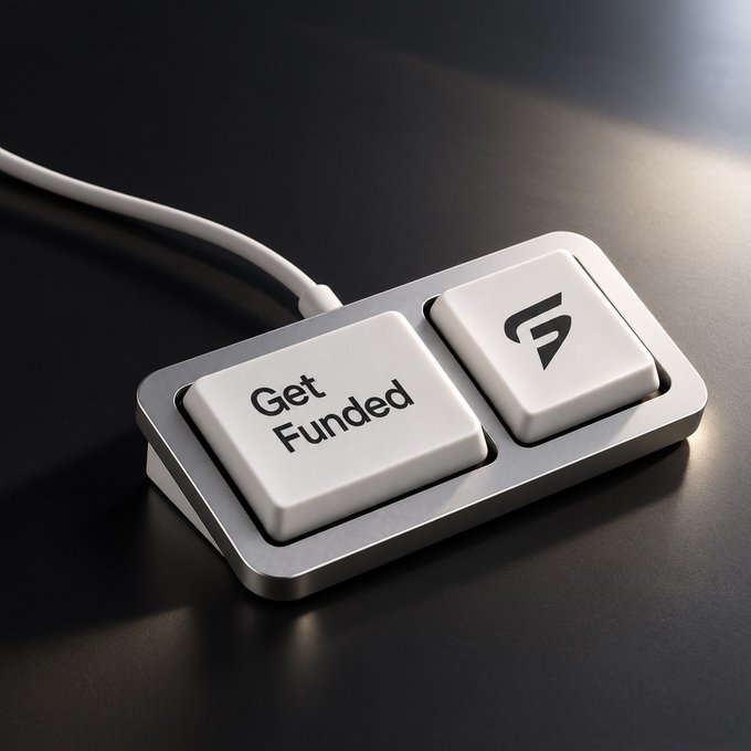 A compact two-button mechanical keyboard-style device with one key labeled 'Get Funded' and another with a logo, sitting on a dark surface with dramatic lighting.