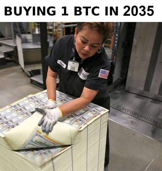 A meme image captioned 'BUYING 1 BTC IN 2035' showing a factory worker handling a massive pallet of bundled US dollar bills, watermarked @CRyptoplayhouse.