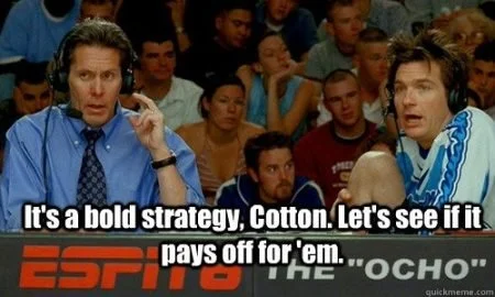 A still from the movie 'Dodgeball' showing Will Ferrell and another commentator at the ESPN8 'The Ocho' broadcast, with the caption: 'It's a bold strategy, Cotton. Let's see if it pays off for 'em.'