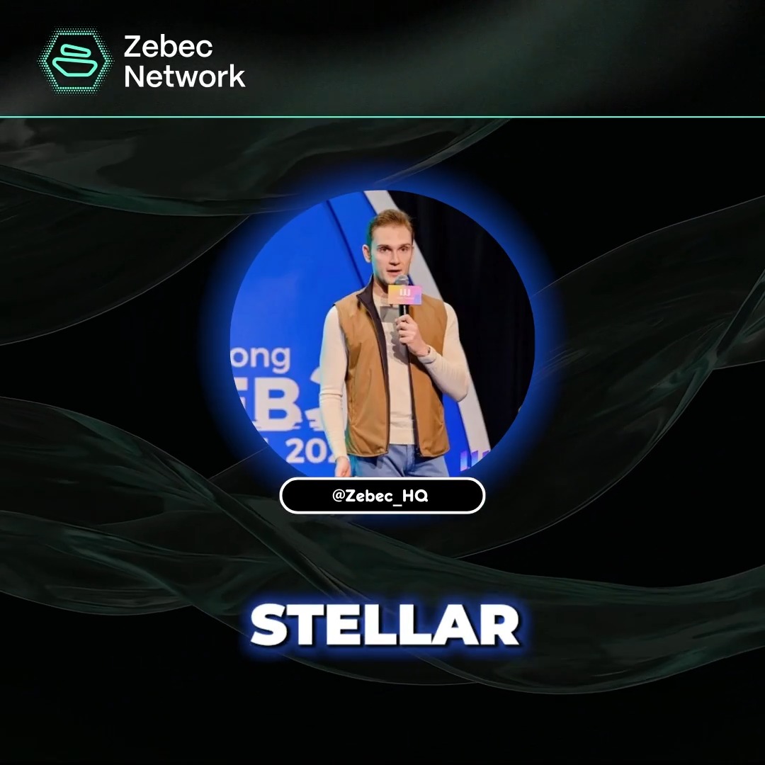The image shows a man standing next to a microphone, holding it up as if he's speaking at an event or giving a presentation. The background of the image is black with blue lines that create a wave-like pattern. There are also some text elements in the image, including "XLM belongs in the real utility conversation." and "Focus on what is in the image and how it relates to the post."