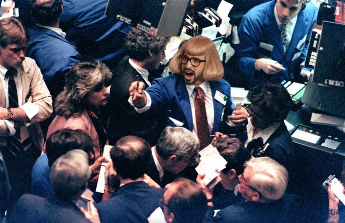 A trader on the floor of the New York Stock Exchange excitedly shouts and gestures amid a crowd of brokers, capturing the chaotic energy of the trading floor. The accompanying caption references a crypto token called JEUS being live on "cetus," though no such text is visible in the image itself.