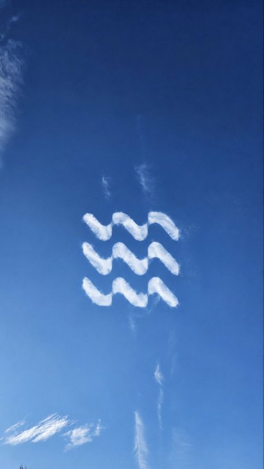 The image features a blue sky with white clouds, which are being used as a canvas for drawing a logo. The logo consists of five lines that form the shape of a wave or a fish. The caption above the image reads "When the sky starts drawing the logo for you, maybe it's time to pay attention." This message encourages viewers to focus on the artwork and appreciate its creativity rather than being distracted by other things happening around them.