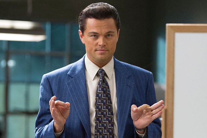 Leonardo DiCaprio, dressed in a blue pinstripe suit with a patterned tie, gestures with both hands while speaking in what appears to be an office setting. The image is being used to illustrate the post about $BTC and ZCash, possibly referencing his famous role in "The Wolf of Wall Street" to evoke themes of bold financial moves or market hype.