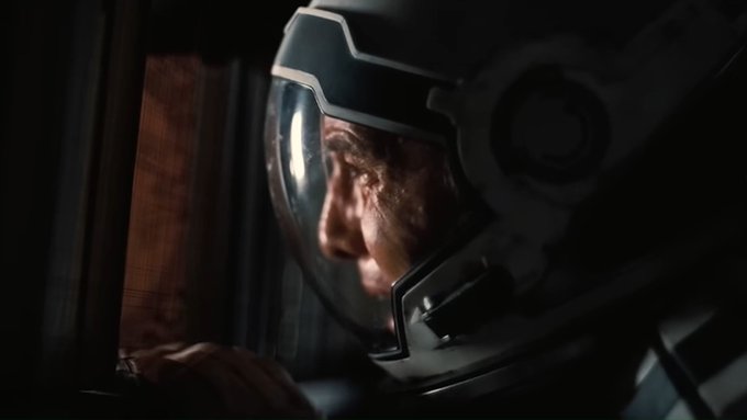 A man in a space helmet peers out from inside a dimly lit spacecraft, his face visible through the visor as he gazes forward. The image humorously captures the feeling of regret and isolation, mirroring the post's sentiment about watching oneself sell Bitcoin and feeling lost in the void.