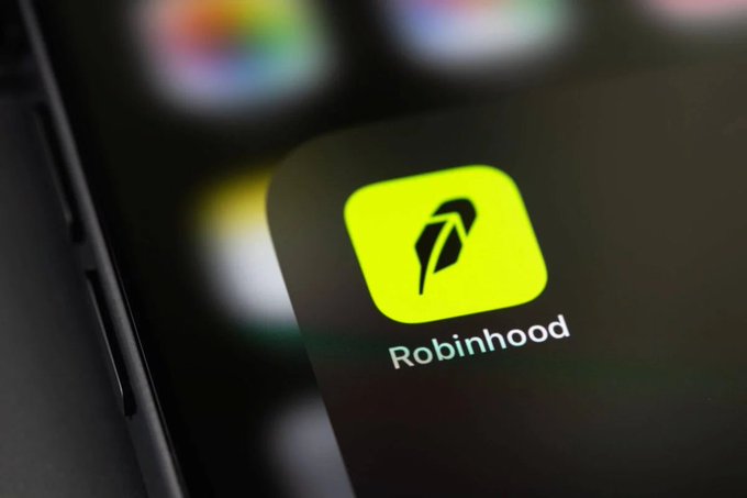 The Robinhood app icon, featuring its signature neon green feather logo, is displayed on a smartphone screen. This visual aligns with the announcement of Robinhood's equity stake in prediction markets and the milestone of event contract revenue reaching $156M in Q2.