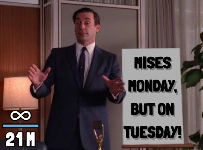 The image features a man dressed in a suit standing in front of a whiteboard with the text "Mises Monday, But On Tuesday!" written above him. The man appears to be giving a speech or presentation, as he is holding up his hands while speaking. The presence of the whiteboard and the man's attire suggest that this could be an event related to a political or academic discussion, possibly about the importance of privacy in modern society.