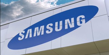 A Samsung logo sign on the exterior of a building under a partly cloudy sky.