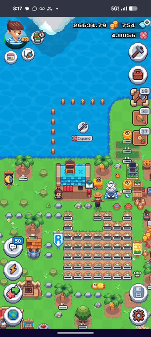 A pixel art mobile game screenshot showing a base-building idle game with resources like 26634.79 coins, 754 gems, and 40056 pink crystals, featuring an 'Expand' option over water and various upgrade buildings.