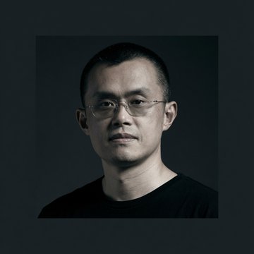 A portrait photograph of CZ (Changpeng Zhao), founder of Binance, shown in a dark-toned studio shot wearing glasses and a black shirt. The image accompanies his comments about Binance's EU MiCA application facing delays due to political complications rather than compliance issues.