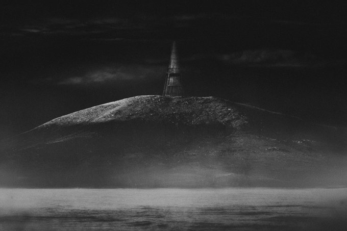 A dark, monochromatic digital artwork depicting a tall spire or tower perched atop a mist-covered mountain under a stormy sky.