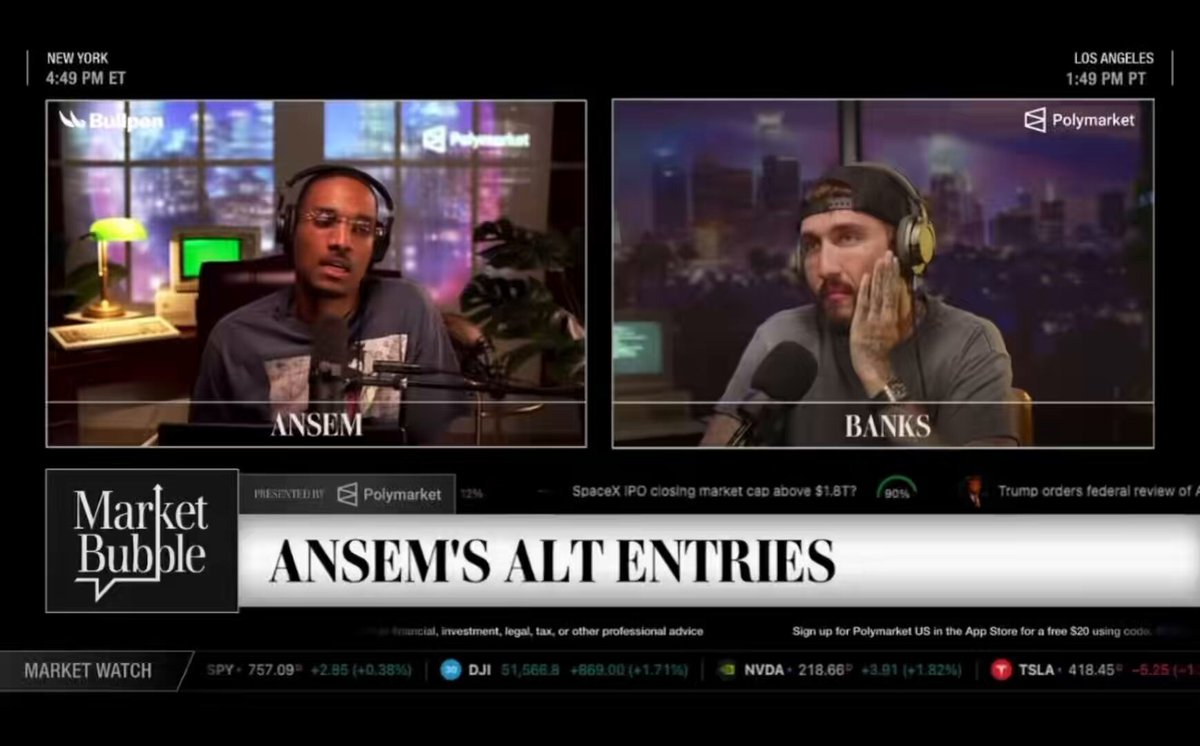 The image shows a television screen displaying two men talking about cryptocurrency markets. One man is wearing headphones while the other has his hand up to his face. The background of the scene features a cityscape, indicating that they are discussing market trends or news related to Bitcoin and altcoins in an urban setting.