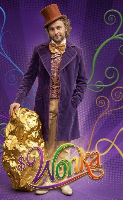 Promotional poster for 'Wonka' featuring actor Timothée Chalamet as Willy Wonka in a purple velvet coat and brown top hat, standing beside a large golden rock.