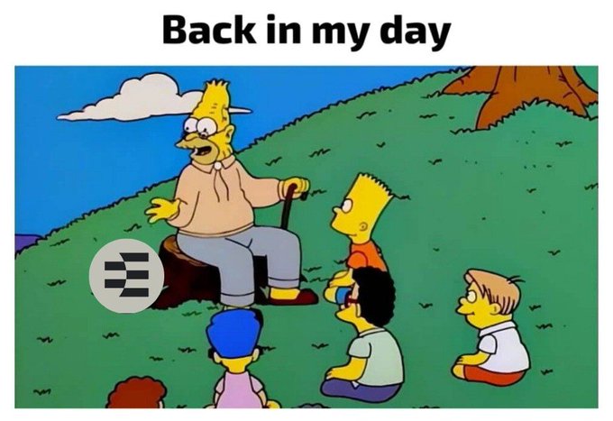 A Simpsons meme captioned 'Back in my day' shows Grandpa Abe Simpson sitting on a stump with his cane, telling stories to Bart and other children on a grassy hill.