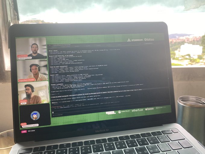 iced coffee and a laptop screen displaying code for a video conference call with three participants, including a man's face on the left side of the screen.
