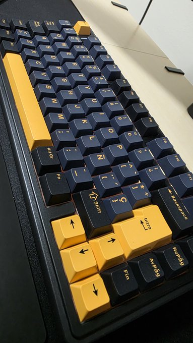 A black mechanical keyboard features striking yellow accent keys—including the spacebar, shift, and arrow keys—mirroring Zcash's signature black and gold color scheme associated with the cryptocurrency's branding.