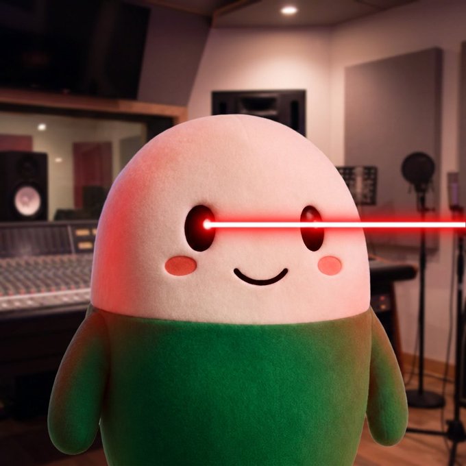 A cute plush character with red laser beam eyes stands in a recording studio, suggesting an intense focus or "locked in" energy that mirrors the bullish sentiment of the post about $Cupsey going up.
