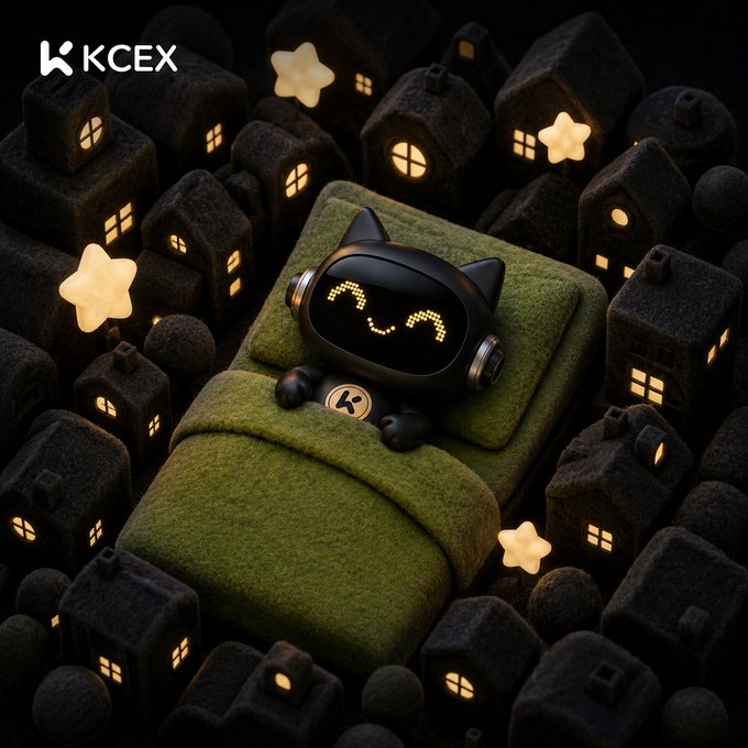 A 3D render shows a black robot cat character with a smiling LED face sleeping in a green bed, surrounded by a miniature dark village with glowing windows and stars, branded with "KCEX".