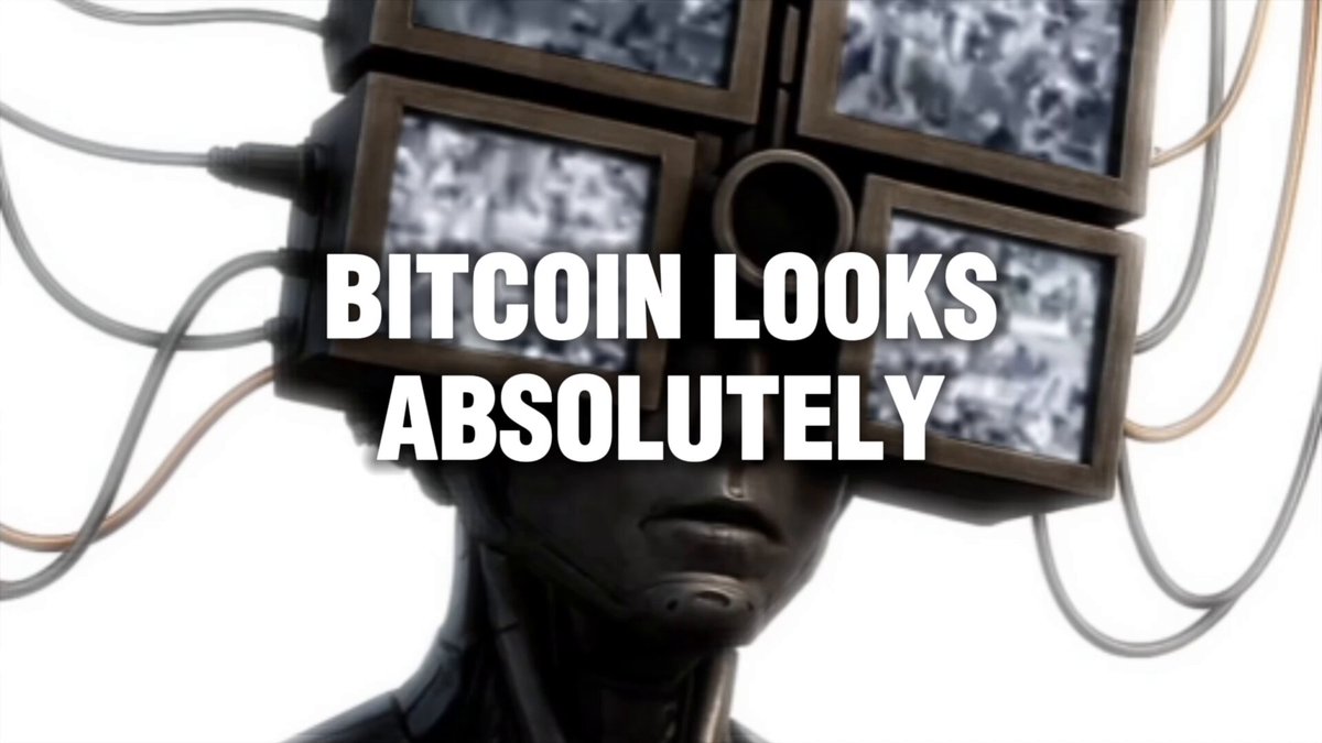 The image features a person wearing a headpiece that has multiple screens attached to it, with the words "BITCOIN LOOKS ABSOLUTELY" written above them. The person appears to be wearing a headset or a headband with screens on their head. This unusual display of technology suggests that the individual is likely promoting or discussing Bitcoin in some way.
