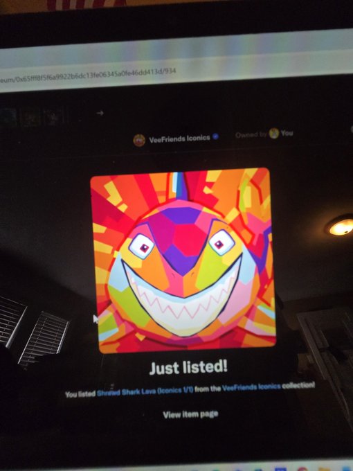 Screen showing a colorful 'Just listed!' notification for 'Shrap! Shark Lava Iconics 1/1' from the VeeFriends Iconics collection on OpenSea.