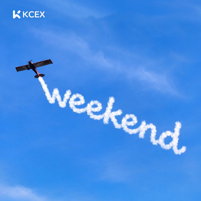A small red and white airplane flying through a blue sky, leaving a smoke trail that spells out 'Weekend', with the 'KCEX' logo in the corner.