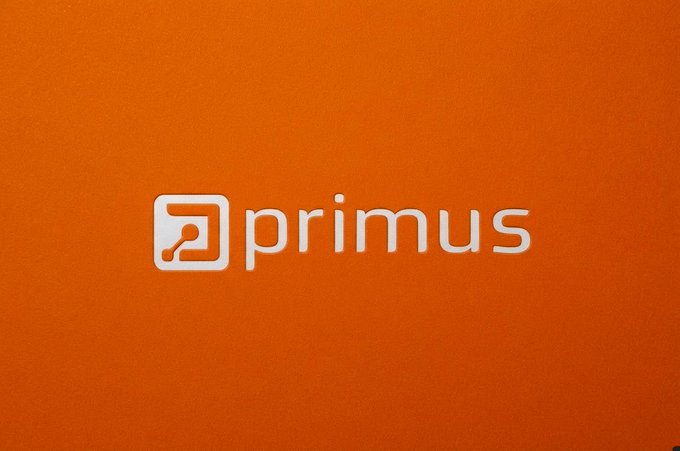 An orange background displaying the white "primus" logo with a small square icon containing a key symbol.