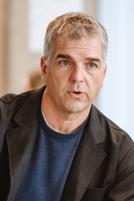 The image features a man wearing a blue shirt with his chin resting on his hand while looking at the camera. The photo has been captioned "NEW: Bitcoin Treasury Companies Don't Have the Right Capital Structure. They Don'T Have the Ability to Deploy Bitcoin." This suggests that there is an ongoing discussion about the challenges faced by Bitcoin companies in terms of their capital structure and ability to deploy Bitcoins effectively.
