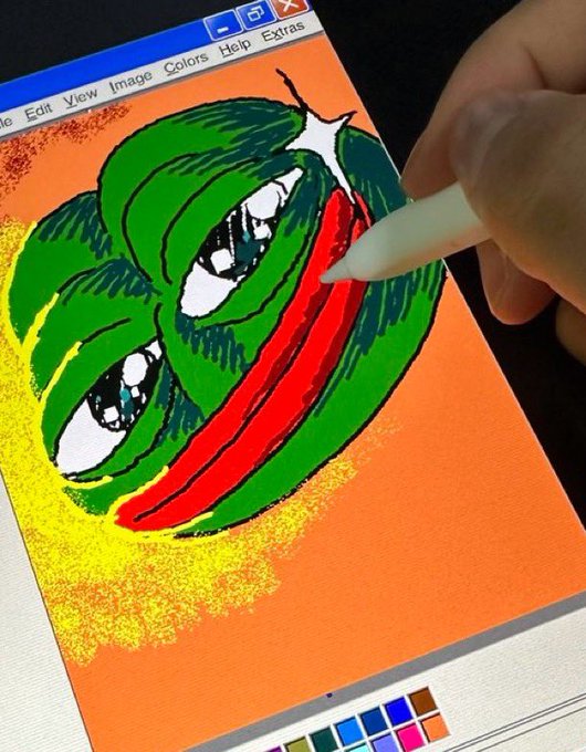 The image features a person using a white stylus pen to draw a cartoon frog on an orange background, which appears to be a painting or a digital art piece. The drawing of the frog includes a face with eyes and a mouth, giving it a unique character. The text in the image reads "GM $PEPE fam. Keep your memes tight and your bags tighter." This message seems to be related to the cartoon frog's theme, as it is a popular meme among fans of the character.