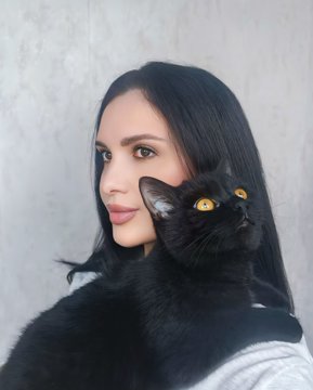 A young woman with long dark hair poses alongside a black cat with striking yellow eyes, the cat's dark fur blending seamlessly with her outfit. The image appears to be the "PHOTO" reference for a digital art piece being created, contrasting a real-life subject with its "Keeper of Shadows" hand-drawn interpretation.