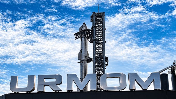 A SpaceX rocket on a launch pad stands behind a large sign reading "URMOM," satirizing the meme-style crypto endorsements with the text framing "$urmom" as the supposed reason behind receiving SpaceX tokenized stock.