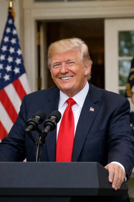 President Trump smiles while speaking at a podium with an American flag behind him, likely announcing support for removing taxes on Bitcoin and crypto transactions.