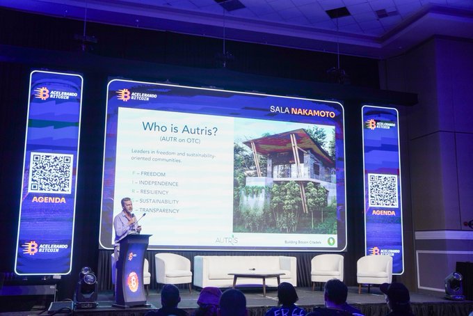 A conference presentation titled "Who is Autris?" at the Accelerando Bitcoin event in Sala Nakamoto, listing values like Freedom, Independence, and Sustainability, with a speaker at a podium.
