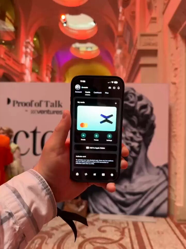 The image shows a person holding up their phone, which displays an app called "@xPortalApp" with a picture of a statue or bust as its background. The text in the image reads "Good to see @xPortalApp still actively engaging in events $EGLD #EGLD #MultiversX". This suggests that the person is interested in the app and possibly attending an event where it might be useful, such as an art exhibit or a historical site with a statue.