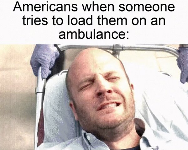 The image features a man lying down in an ambulance bed with his eyes closed. The caption above him reads "America when someone tries to load them on an ambulance." This humorous caption suggests that the image might be related to a meme or joke about the challenges of being transported in an ambulance, and it is likely meant to entertain rather than provide accurate information.