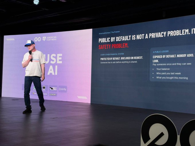 A speaker in a white cap and t-shirt presents on stage about 'PUBLIC BY DEFAULT IS NOT A PRIVACY PROBLEM. IT'S A SAFETY PROBLEM' at a 'Web3' themed event, with the slide featuring 'AmericanFortified'.