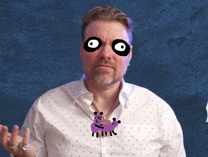 A man wearing a white dotted shirt has cartoon black mask eyes digitally added to his face, with a purple cartoon sheep superimposed over his chest area.